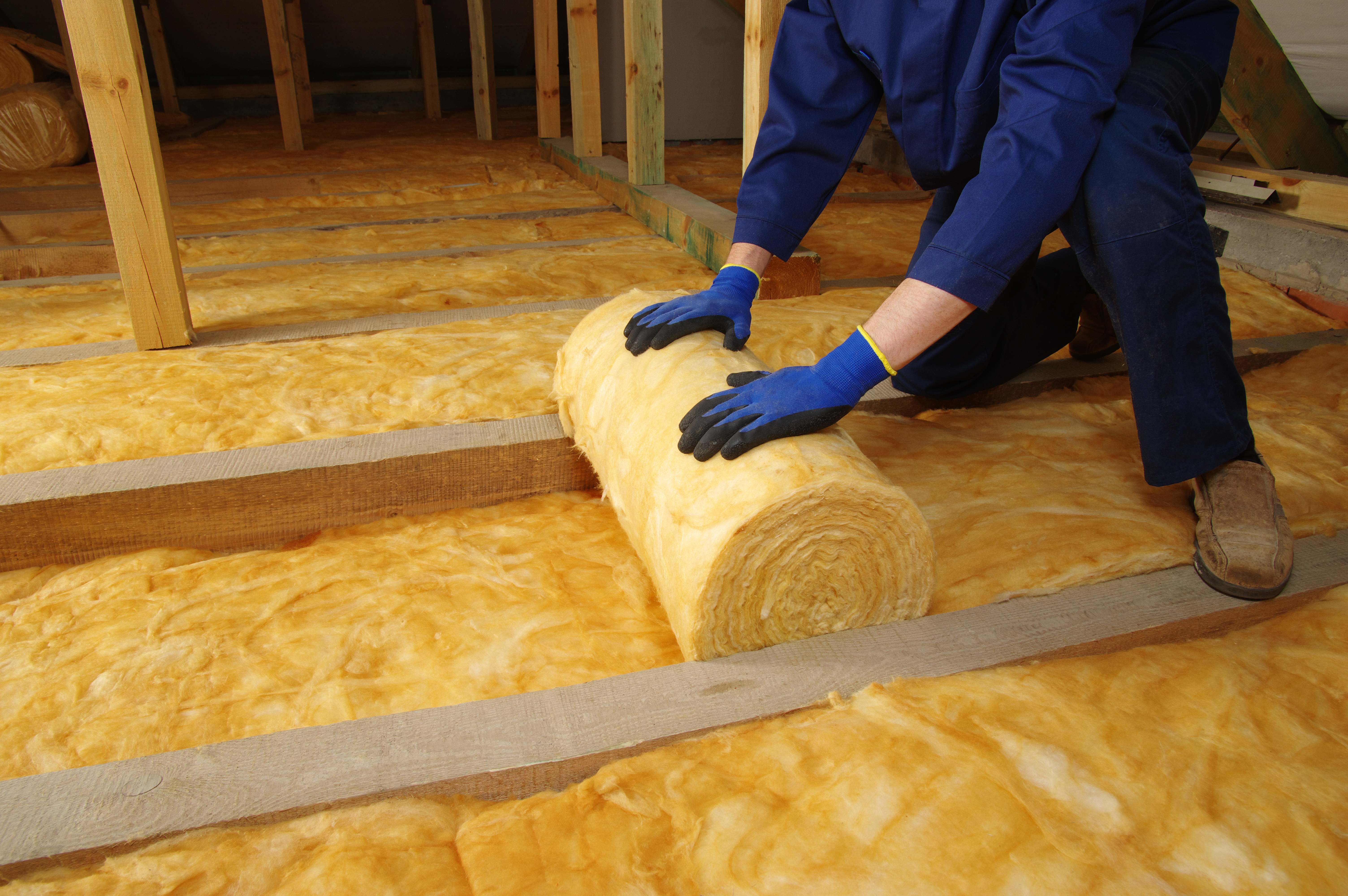 Man,Installing,Thermal,Insulation,Layer,Under,The,Roof,,Using,Mineral